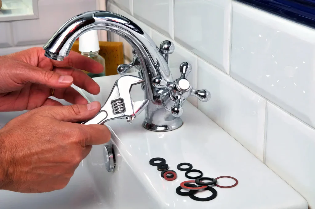Plumber performing maintenance on a bathroom faucet in Watsonville