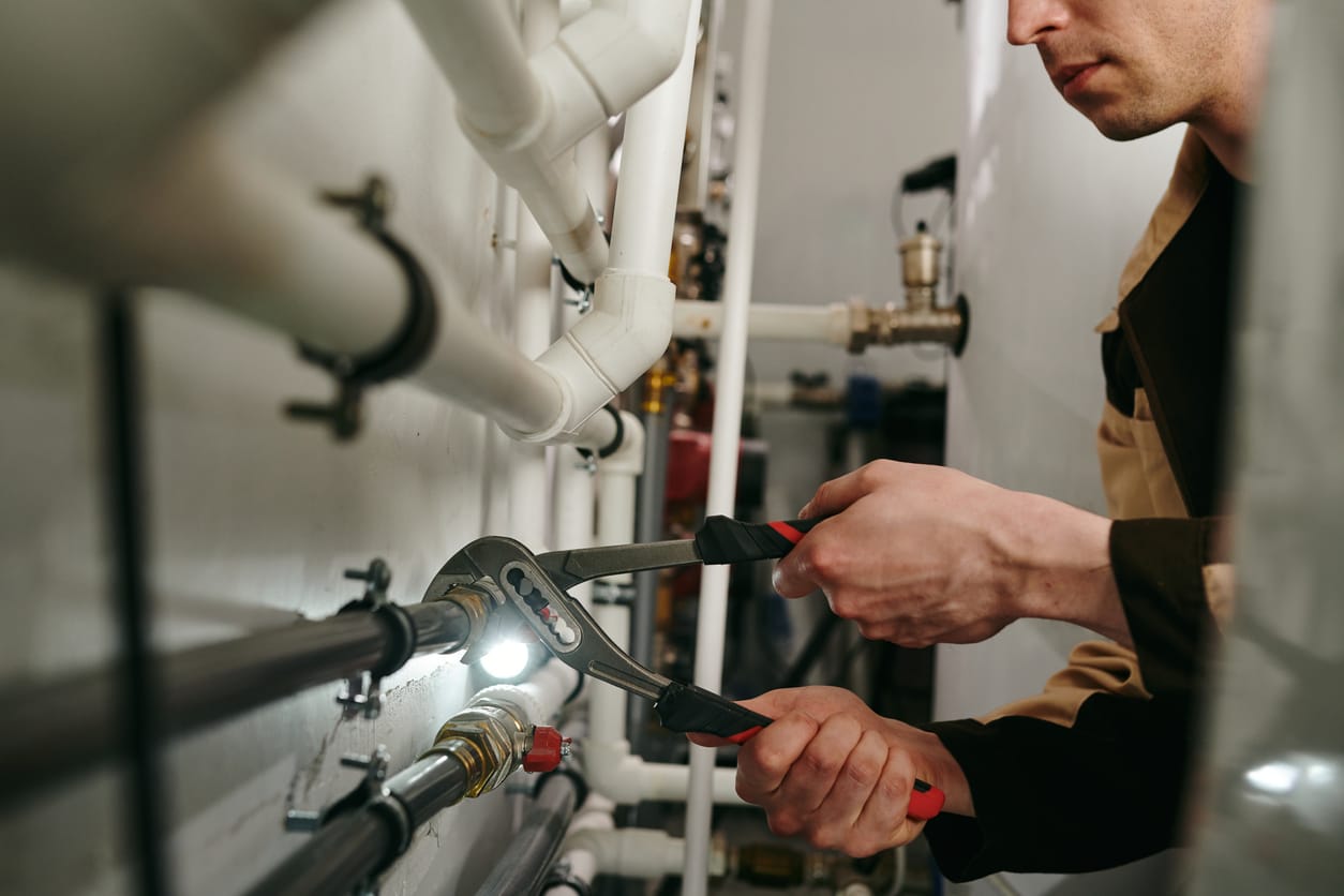 Plumbers maintaining commercial plumbing pipes in Watsonville