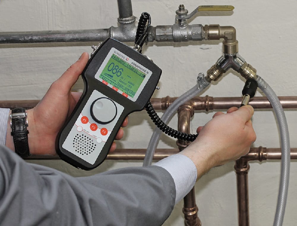 Plumber testing pipes with electronic leak detection equipment in Watsonville