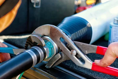 Technician tightening an industrial pipe connection in Watsonville