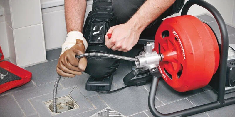 Plumber using a drain-cleaning machine in Watsonville