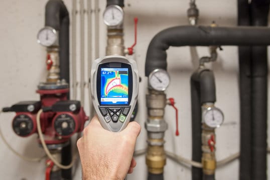 Plumber using a thermal imaging camera to inspect pipes in Watsonville