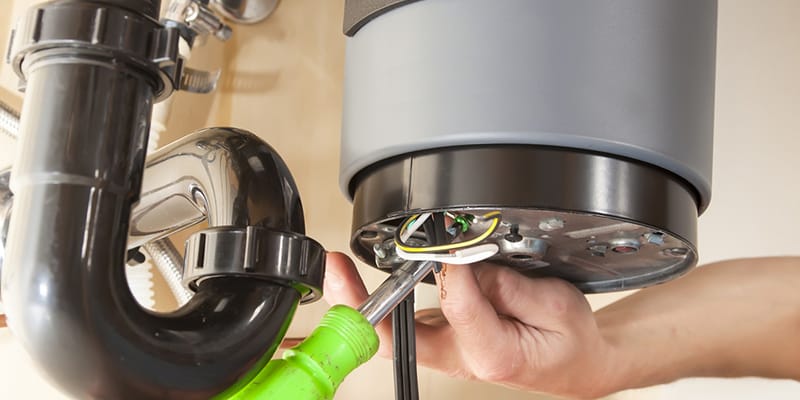 Technician repairing the heating element of a water heater in Watsonville