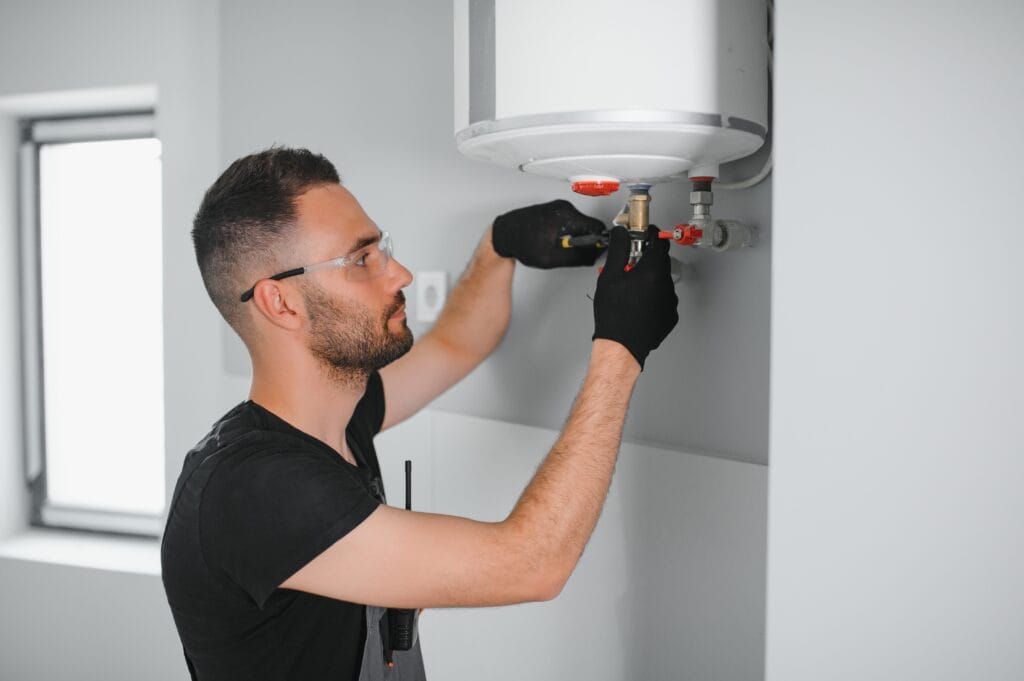 Technician performing water heater maintenance in Watsonville