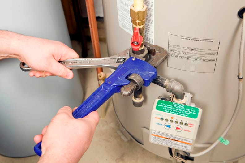 Plumber repairing a water heater valve in Watsonville
